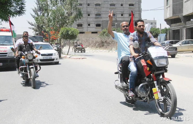 Palestinians ride motorcycles and carry the Palestinian flag during a demonstration organized by the National Authority for Return and Breaking the Siege in Gaza City, June 5, 2018. Photo by Mahmoud Ajour