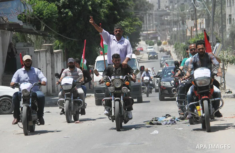 Palestinians ride motorcycles and carry the Palestinian flag during a demonstration organized by the National Authority for Return and Breaking the Siege in Gaza City, June 5, 2018. Photo by Mahmoud Ajour