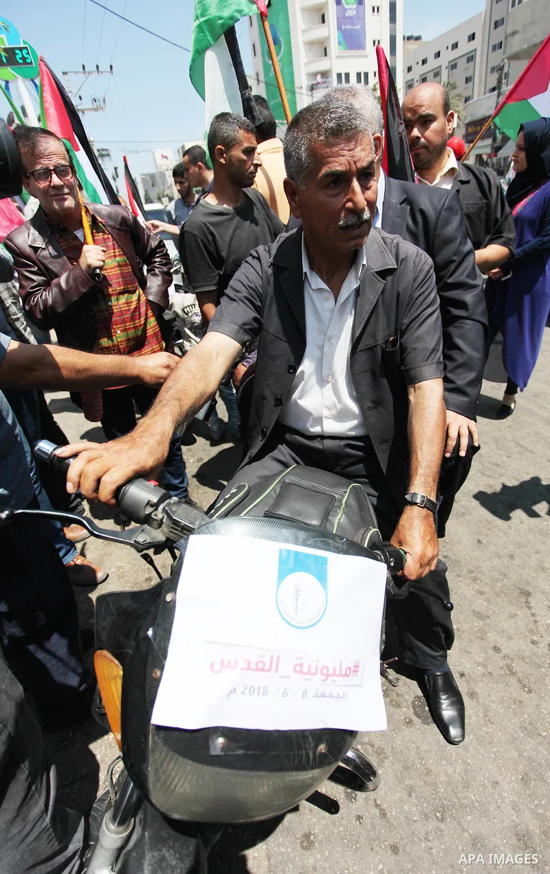 Palestinians ride motorcycles and carry the Palestinian flag during a demonstration organized by the National Authority for Return and Breaking the Siege in Gaza City, June 5, 2018. Photo by Mahmoud Ajour