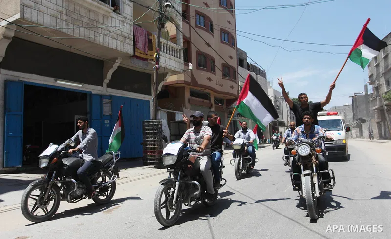 Palestinians ride motorcycles and carry the Palestinian flag during a demonstration organized by the National Authority for Return and Breaking the Siege in Gaza City, June 5, 2018. Photo by Mahmoud Ajour