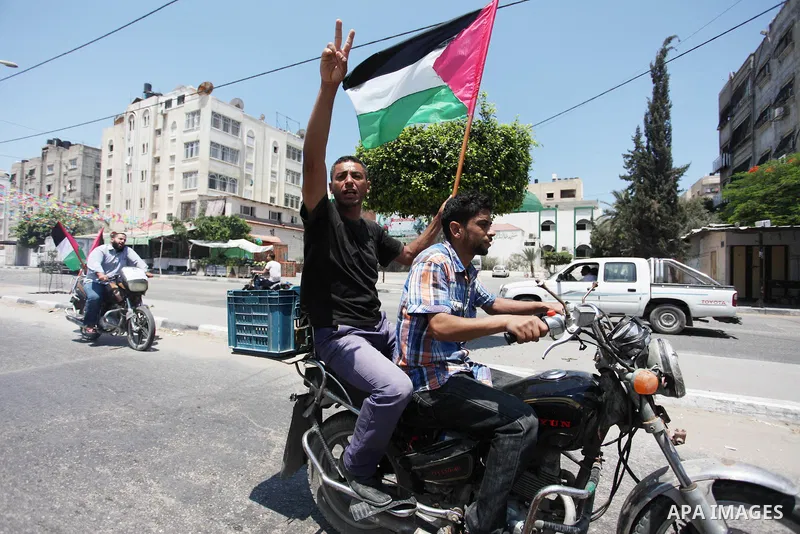 Palestinians ride motorcycles and carry the Palestinian flag during a demonstration organized by the National Authority for Return and Breaking the Siege in Gaza City, June 5, 2018. Photo by Mahmoud Ajour