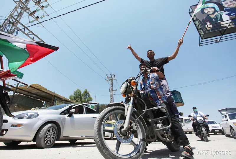 Palestinians ride motorcycles and carry the Palestinian flag during a demonstration organized by the National Authority for Return and Breaking the Siege in Gaza City, June 5, 2018. Photo by Mahmoud Ajour