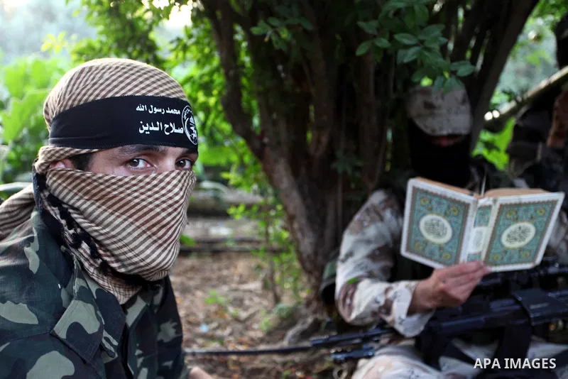 Palestinian militants of al-Nasser Salah al-Deen Brigades, the military wing of the Popular Resistance Committees, take part in a protest to solidaratiy with Jerusalem, in Gaza city, on June 5, 2018. Photo by Mahmoud Ajo...