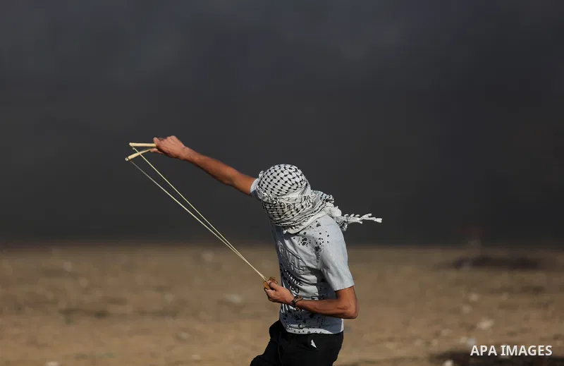 Palestinian protesters gather during clashes with Israeli security froces in a tent city protest where Palestinians demand the right to return to their homeland and against U.S. embassy move to Jerusalem at the Israel-Ga...