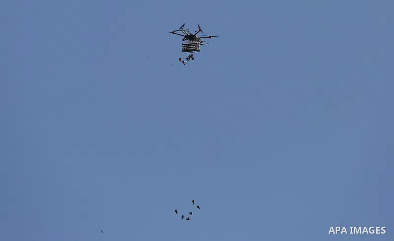 A picture taken 05 June 2018 shows an Israeli quadcopter drone flying over Palestinian protesters and throw tear gas canisters during clashes in a tent city protest where Palestinians demand the right to return to their...