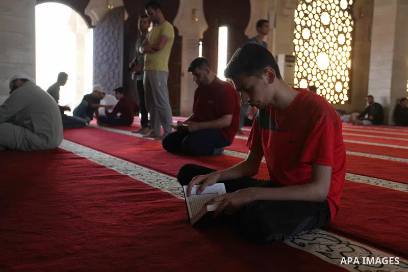 Palestinians read the Koran, Islam's holiest book, at a mosque in Gaza City during the Muslim holy month of Ramadan, on June 6, 2018. Ramadan is sacred to Muslims because it is during that month that tradition says the K...