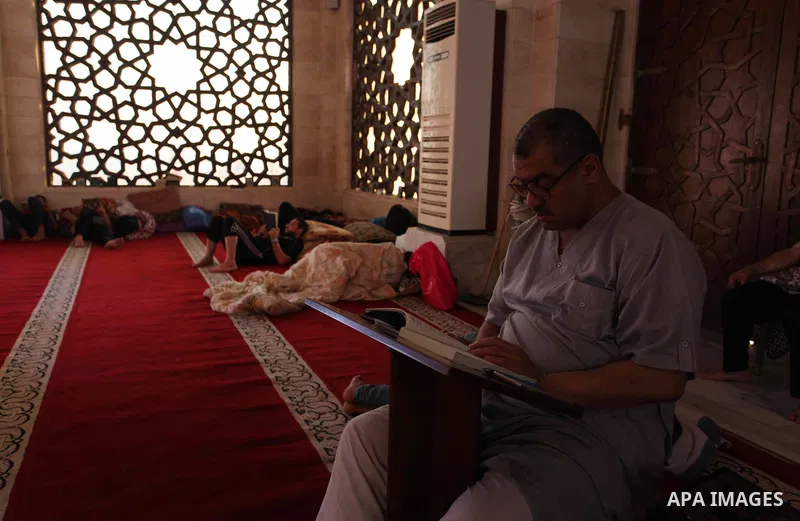 A Palestinian man reads the Koran, Islam's holiest book, at a mosque in Gaza City during the Muslim holy month of Ramadan, on June 6, 2018. Ramadan is sacred to Muslims because it is during that month that tradition says...