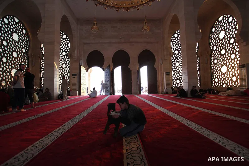 A Palestinian man reads the Koran, Islam's holiest book, at a mosque in Gaza City during the Muslim holy month of Ramadan, on June 6, 2018. Ramadan is sacred to Muslims because it is during that month that tradition says...