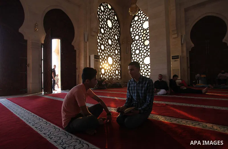 Palestinians read the Koran, Islam's holiest book, at a mosque in Gaza City during the Muslim holy month of Ramadan, on June 6, 2018. Ramadan is sacred to Muslims because it is during that month that tradition says the K...