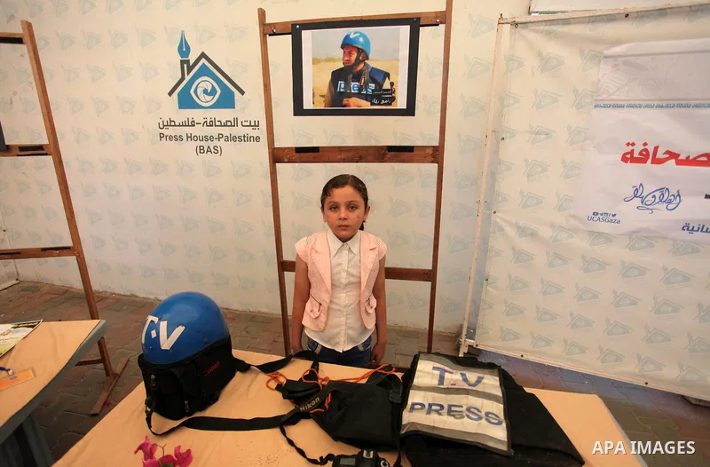 Palestinians attend an exhibition collectibles of martyrs journalists, in Gaza City on May 7, 2016. Photo by Mahmoud Ajour