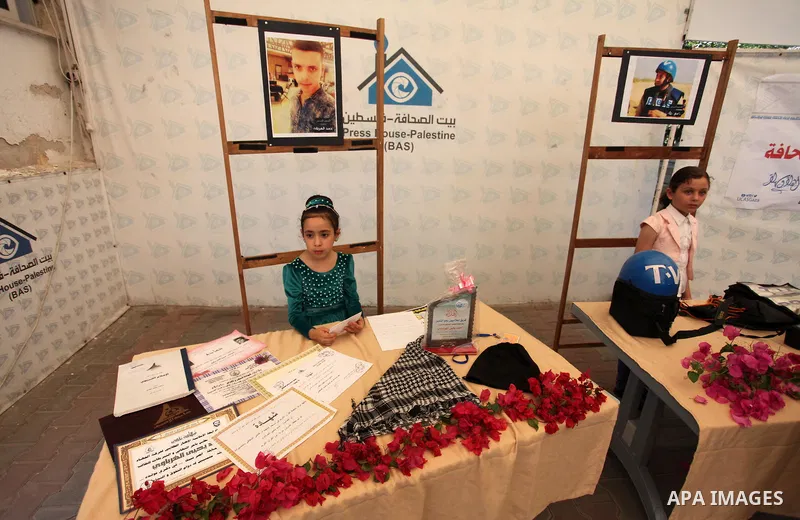 Palestinians attend an exhibition collectibles of martyrs journalists, in Gaza City on May 7, 2016. Photo by Mahmoud Ajour