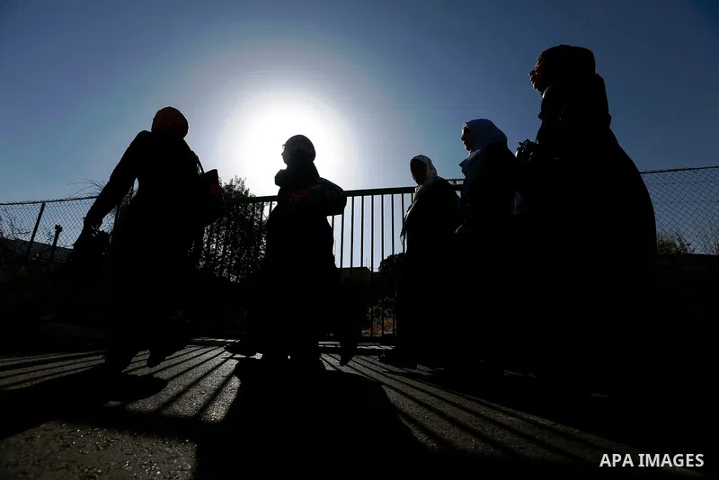 Palestinians make their way through an Israeli checkpoint along Israel's controversial separation barrier to attend the last Friday prayer of the holy fasting month of Ramadan in Jerusalem's Al-Aqsa mosque, in Bethlehem...