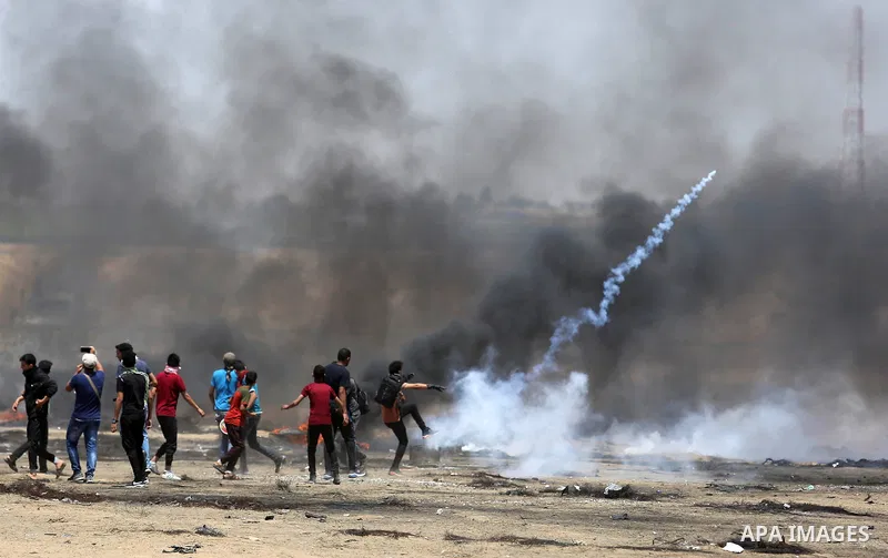 Palestinian protesters gather during clashes with Israeli troops in a protest marking al-Quds Day, (Jerusalem Day), at the Israel-Gaza border in Khan Younis in the southern Gaza Strip on June 8, 2018. Photo by Ashraf Amr...