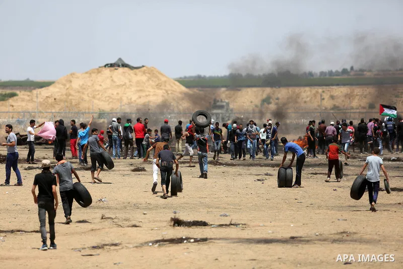 Palestinian protesters gather during clashes with Israeli troops in a protest marking al-Quds Day, (Jerusalem Day), at the Israel-Gaza border in Khan Younis in the southern Gaza Strip on June 8, 2018. Photo by Ashraf Amr...
