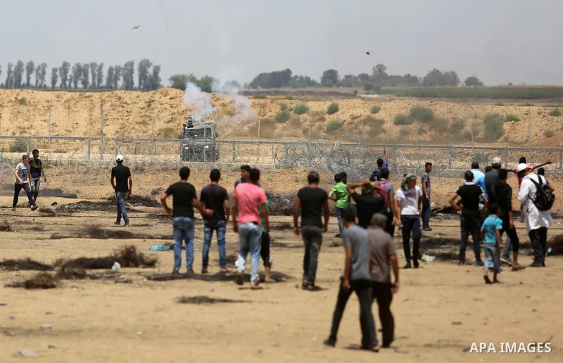 Palestinian protesters gather during clashes with Israeli troops in a protest marking al-Quds Day, (Jerusalem Day), at the Israel-Gaza border in Khan Younis in the southern Gaza Strip on June 8, 2018. Photo by Ashraf Amr...