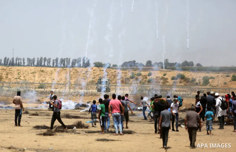 Palestinian protesters gather during clashes with Israeli troops in a protest marking al-Quds Day, (Jerusalem Day), at the Israel-Gaza border in Khan Younis in the southern Gaza Strip on June 8, 2018. Photo by Ashraf Amr...