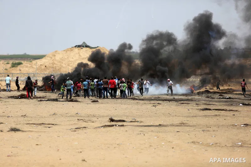 Palestinian protesters gather during clashes with Israeli troops in a protest marking al-Quds Day, (Jerusalem Day), at the Israel-Gaza border in Khan Younis in the southern Gaza Strip on June 8, 2018. Photo by Ashraf Amr...