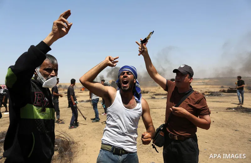 Palestinian protesters gather during clashes with Israeli troops in a protest marking al-Quds Day, (Jerusalem Day), at the Israel-Gaza border in Khan Younis in the southern Gaza Strip on June 8, 2018. Photo by Ashraf Amr...