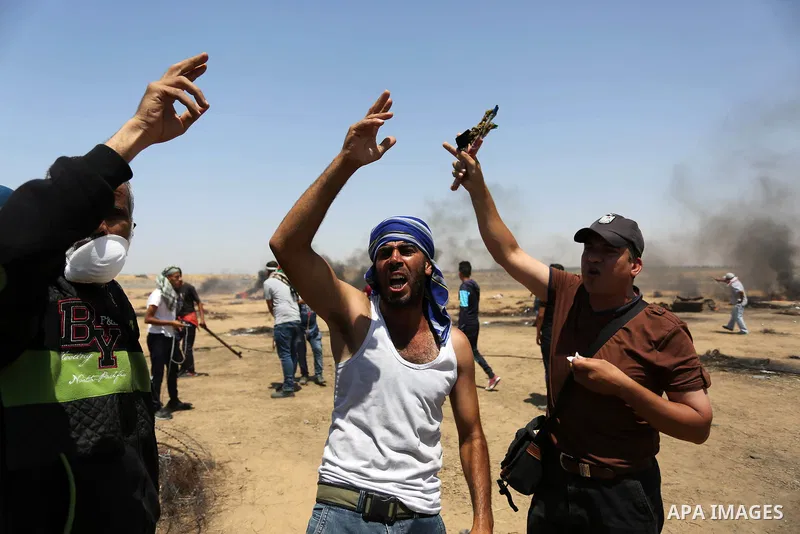 Palestinian protesters gather during clashes with Israeli troops in a protest marking al-Quds Day, (Jerusalem Day), at the Israel-Gaza border in Khan Younis in the southern Gaza Strip on June 8, 2018. Photo by Ashraf Amr...