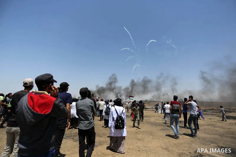 Palestinian protesters gather during clashes with Israeli troops in a protest marking al-Quds Day, (Jerusalem Day), at the Israel-Gaza border in Khan Younis in the southern Gaza Strip on June 8, 2018. Photo by Ashraf Amr...