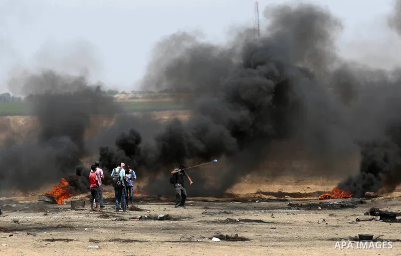 Palestinian protesters gather during clashes with Israeli troops in a protest marking al-Quds Day, (Jerusalem Day), at the Israel-Gaza border in Khan Younis in the southern Gaza Strip on June 8, 2018. Photo by Ashraf Amr...