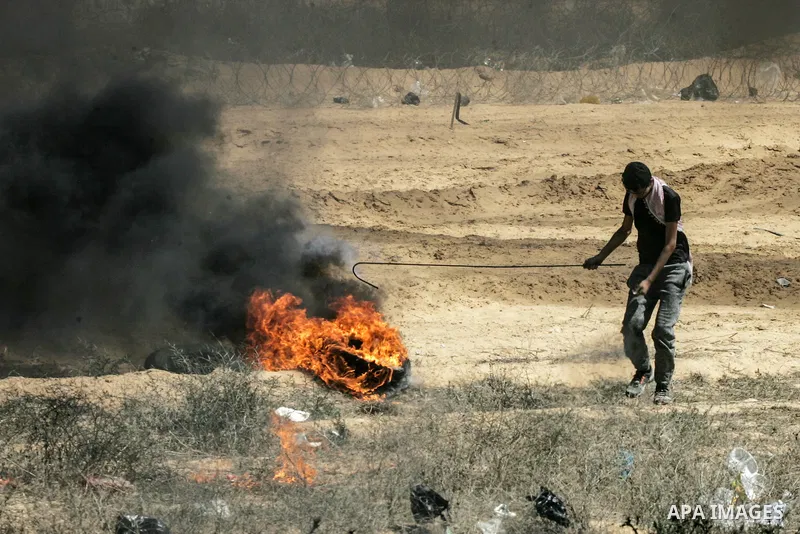 Palestinian protesters gather during clashes with Israeli troops in a protest marking al-Quds Day, (Jerusalem Day), at the Israel-Gaza border in Rafah in the southern Gaza Strip on June 8, 2018. Photo by Mahmoud Bassam