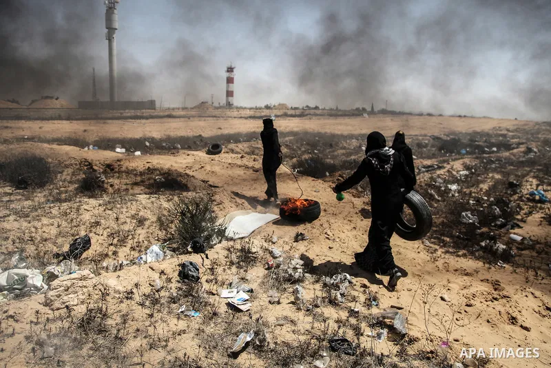 Palestinian protesters gather during clashes with Israeli troops in a protest marking al-Quds Day, (Jerusalem Day), at the Israel-Gaza border in Rafah in the southern Gaza Strip on June 8, 2018. Photo by Mahmoud Bassam