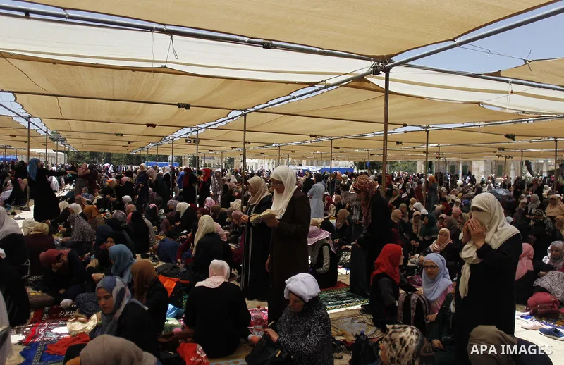 Palestinians gather to perform the last Friday prayers of the Muslim holy month of Ramadan at the Aqsa mosque compound in the old city of Jerusalem on June 8, 2018. Photo by Muammar Awad