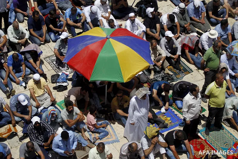 Palestinians gather to perform the last Friday prayers of the Muslim holy month of Ramadan at the Aqsa mosque compound in the old city of Jerusalem on June 8, 2018. Photo by Muammar Awad
