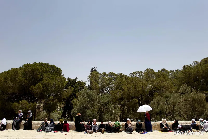 Palestinians gather to perform the last Friday prayers of the Muslim holy month of Ramadan at the Aqsa mosque compound in the old city of Jerusalem on June 8, 2018. Photo by Muammar Awad