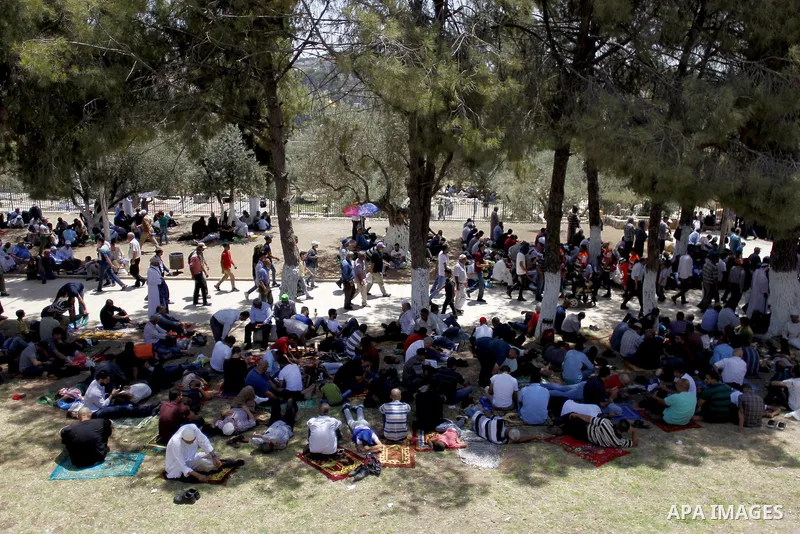 Palestinians gather to perform the last Friday prayers of the Muslim holy month of Ramadan at the Aqsa mosque compound in the old city of Jerusalem on June 8, 2018. Photo by Muammar Awad