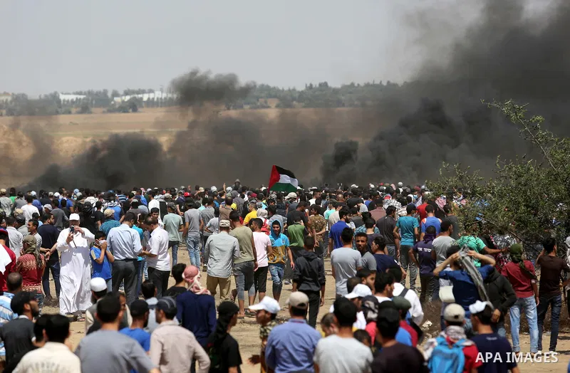 Palestinian protesters gather during clashes with Israeli troops in a protest marking al-Quds Day, (Jerusalem Day), at the Israel-Gaza border in Khan Younis in the southern Gaza Strip on June 8, 2018. Photo by Ashraf Amr...