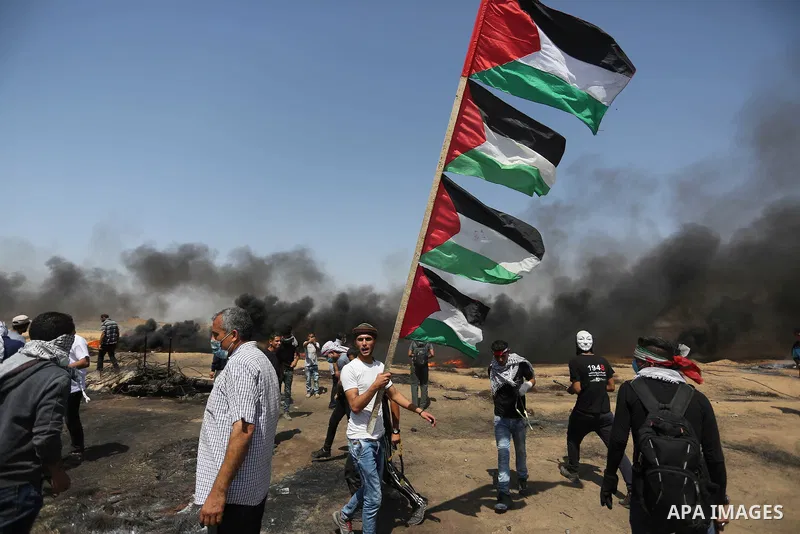 Palestinian protesters gather during clashes with Israeli troops in a protest marking al-Quds Day, (Jerusalem Day), at the Israel-Gaza border in Khan Younis in the southern Gaza Strip on June 8, 2018. Photo by Ashraf Amr...