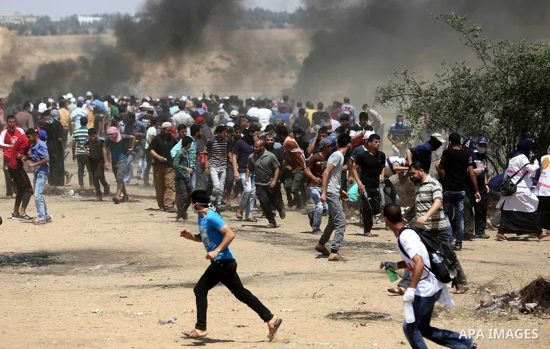 Palestinian protesters gather during clashes with Israeli troops in a protest marking al-Quds Day, (Jerusalem Day), at the Israel-Gaza border in Khan Younis in the southern Gaza Strip on June 8, 2018. Photo by Ashraf Amr...