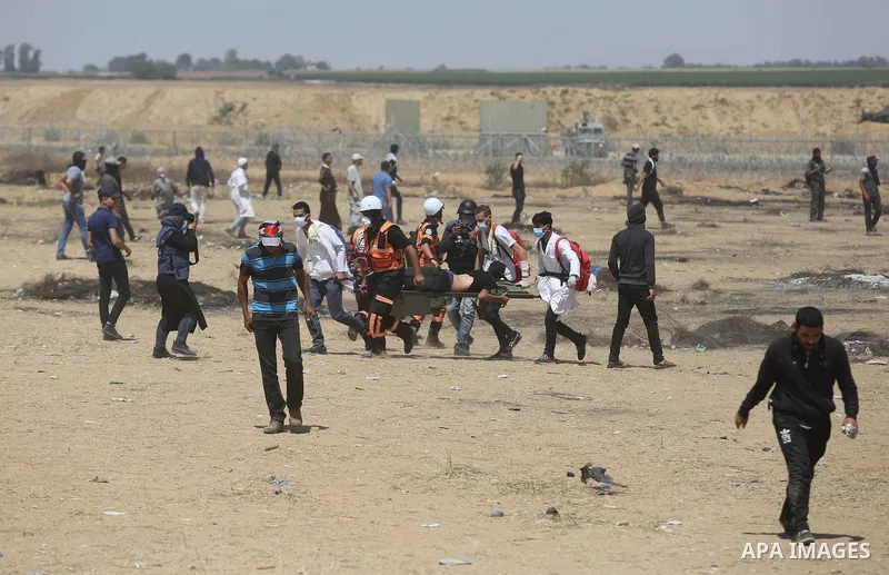 A wounded Palestinian protester is evacuated during clashes with Israeli security froces in a protest marking al-Quds Day, (Jerusalem Day), at the Israel-Gaza border in Khan Younis in the southern Gaza Strip on June 8, 2...