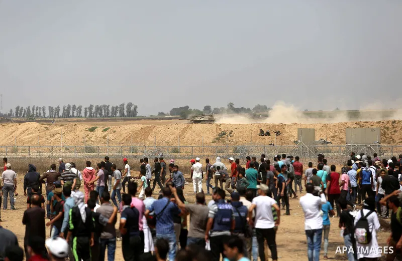 Palestinian protesters gather during clashes with Israeli troops in a protest marking al-Quds Day, (Jerusalem Day), at the Israel-Gaza border in Khan Younis in the southern Gaza Strip on June 8, 2018. Photo by Ashraf Amr...
