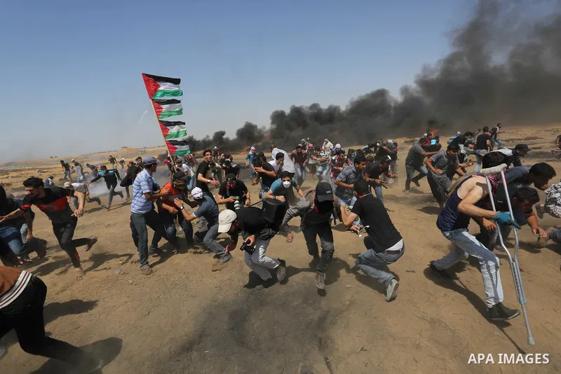 Palestinian protesters gather during clashes with Israeli troops in a protest marking al-Quds Day, (Jerusalem Day), at the Israel-Gaza border in Khan Younis in the southern Gaza Strip on June 8, 2018. Photo by Ashraf Amr...