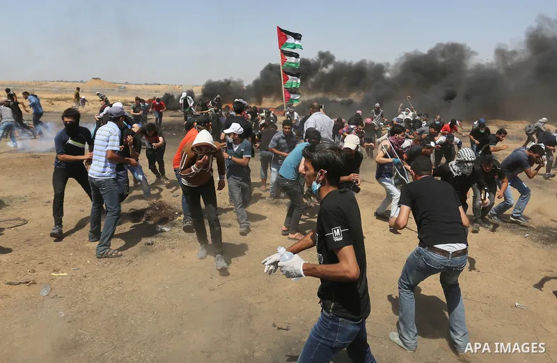 Palestinian protesters gather during clashes with Israeli troops in a protest marking al-Quds Day, (Jerusalem Day), at the Israel-Gaza border in Khan Younis in the southern Gaza Strip on June 8, 2018. Photo by Ashraf Amr...