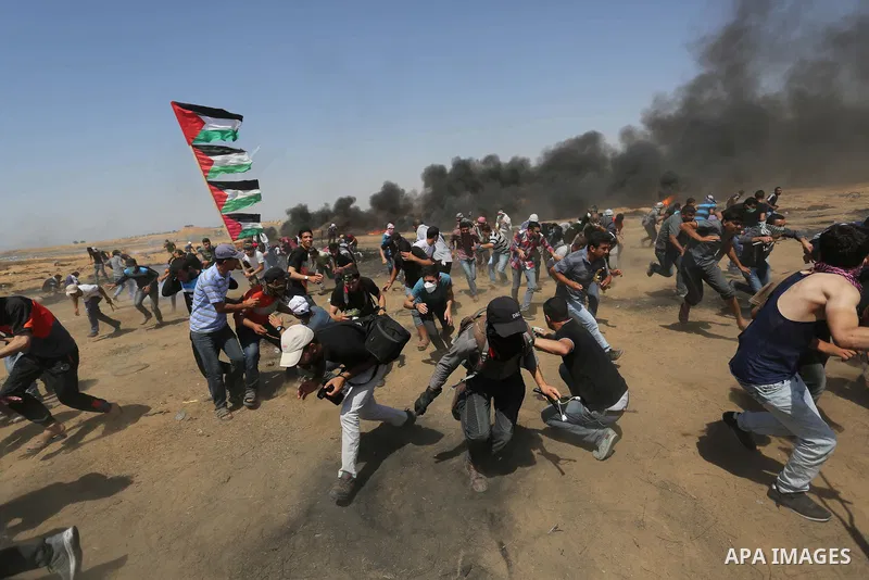 Palestinian protesters gather during clashes with Israeli troops in a protest marking al-Quds Day, (Jerusalem Day), at the Israel-Gaza border in Khan Younis in the southern Gaza Strip on June 8, 2018. Photo by Ashraf Amr...