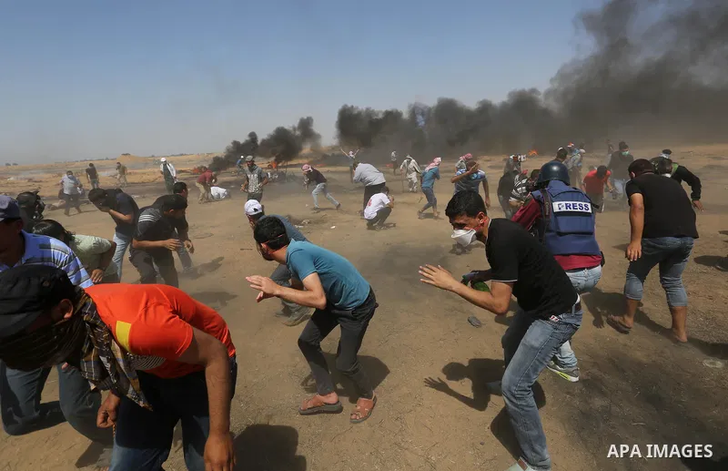 Palestinian protesters gather during clashes with Israeli troops in a protest marking al-Quds Day, (Jerusalem Day), at the Israel-Gaza border in Khan Younis in the southern Gaza Strip on June 8, 2018. Photo by Ashraf Amr...