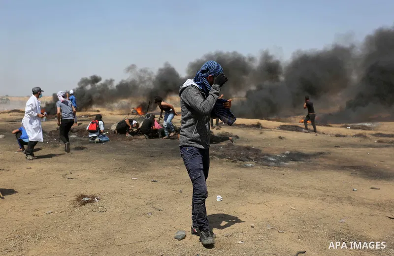 Palestinian protesters gather during clashes with Israeli troops in a protest marking al-Quds Day, (Jerusalem Day), at the Israel-Gaza border in Khan Younis in the southern Gaza Strip on June 8, 2018. Photo by Ashraf Amr...