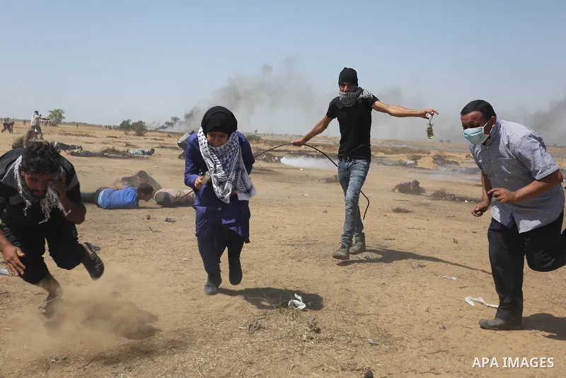 Palestinian protesters gather during clashes with Israeli troops in a protest marking al-Quds Day, (Jerusalem Day), at the Israel-Gaza border in Khan Younis in the southern Gaza Strip on June 8, 2018. Photo by Ashraf Amr...