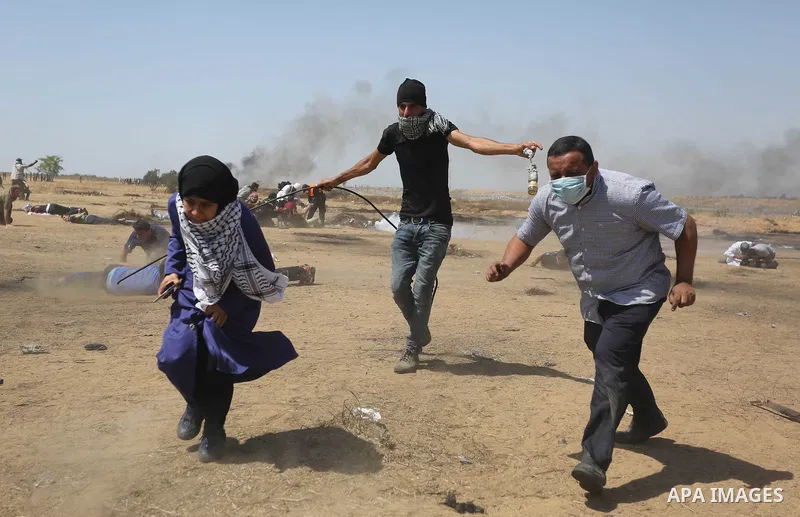 Palestinian protesters gather during clashes with Israeli troops in a protest marking al-Quds Day, (Jerusalem Day), at the Israel-Gaza border in Khan Younis in the southern Gaza Strip on June 8, 2018. Photo by Ashraf Amr...