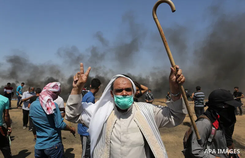 Palestinian protesters gather during clashes with Israeli troops in a protest marking al-Quds Day, (Jerusalem Day), at the Israel-Gaza border in Khan Younis in the southern Gaza Strip on June 8, 2018. Photo by Ashraf Amr...