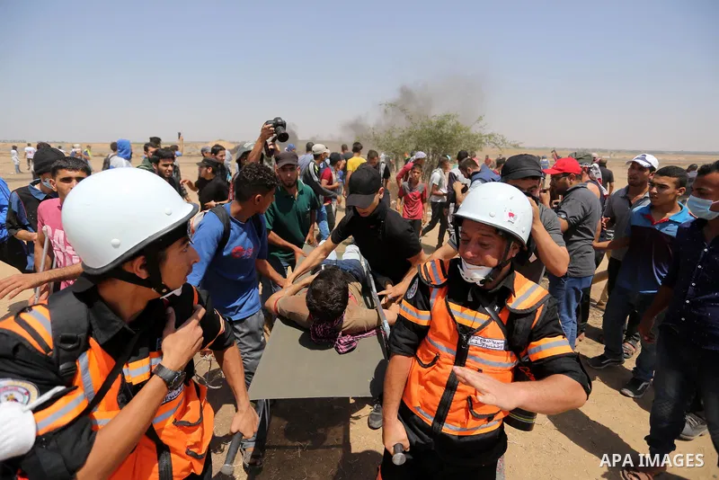 A wounded Palestinian protester is evacuated during clashes with Israeli security froces in a protest marking al-Quds Day, (Jerusalem Day), at the Israel-Gaza border in Khan Younis in the southern Gaza Strip on June 8, 2...