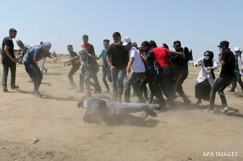 A wounded Palestinian protester is evacuated during clashes with Israeli security froces in a protest marking al-Quds Day, (Jerusalem Day), at the Israel-Gaza border in Khan Younis in the southern Gaza Strip on June 8, 2...