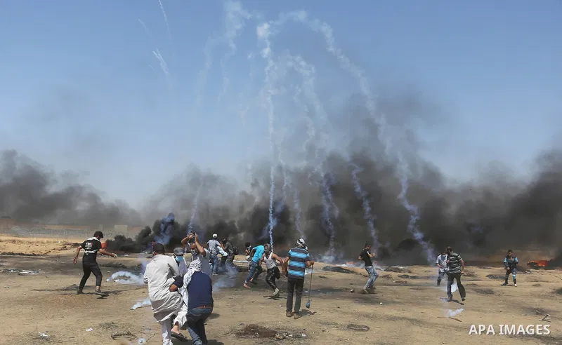 Palestinian protesters gather during clashes with Israeli troops in a protest marking al-Quds Day, (Jerusalem Day), at the Israel-Gaza border in Khan Younis in the southern Gaza Strip on June 8, 2018. Photo by Ashraf Amr...