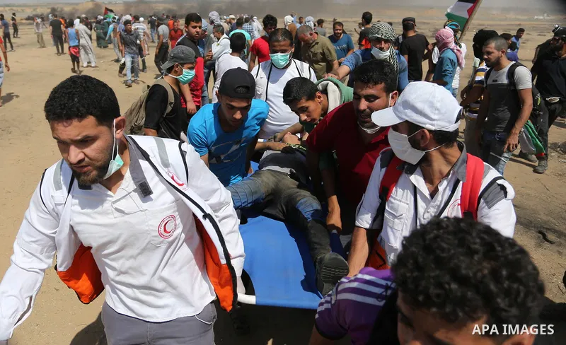 A wounded Palestinian protester is evacuated during clashes with Israeli security froces in a protest marking al-Quds Day, (Jerusalem Day), at the Israel-Gaza border in Khan Younis in the southern Gaza Strip on June 8, 2...