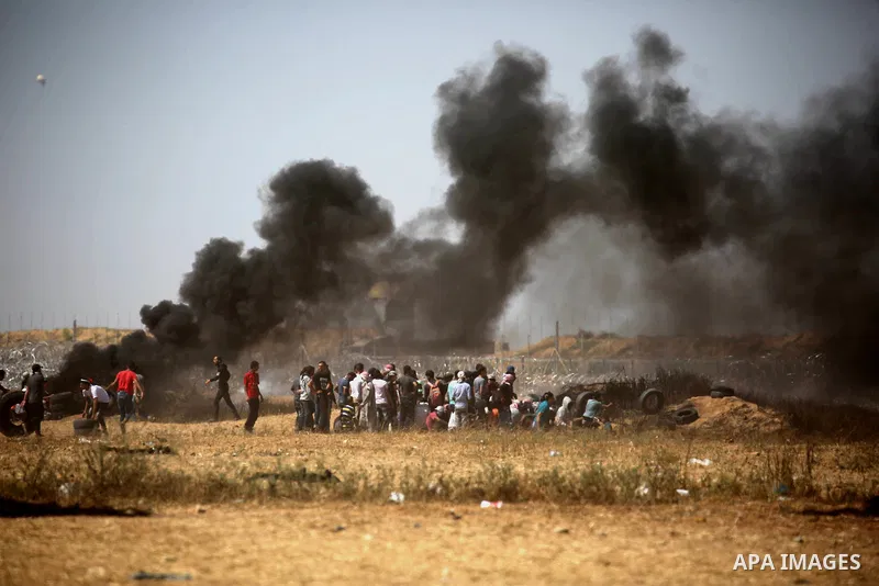Palestinian protesters gather during clashes with Israeli troops in a protest marking al-Quds Day, (Jerusalem Day), at the Israel-Gaza border in Khan Younis in the southern Gaza Strip on June 8, 2018. Photo by Ashraf Amr...
