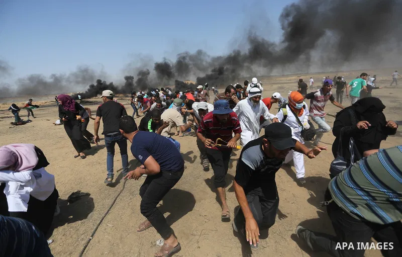 Palestinian protesters gather during clashes with Israeli troops in a protest marking al-Quds Day, (Jerusalem Day), at the Israel-Gaza border in Khan Younis in the southern Gaza Strip on June 8, 2018. Photo by Ashraf Amr...